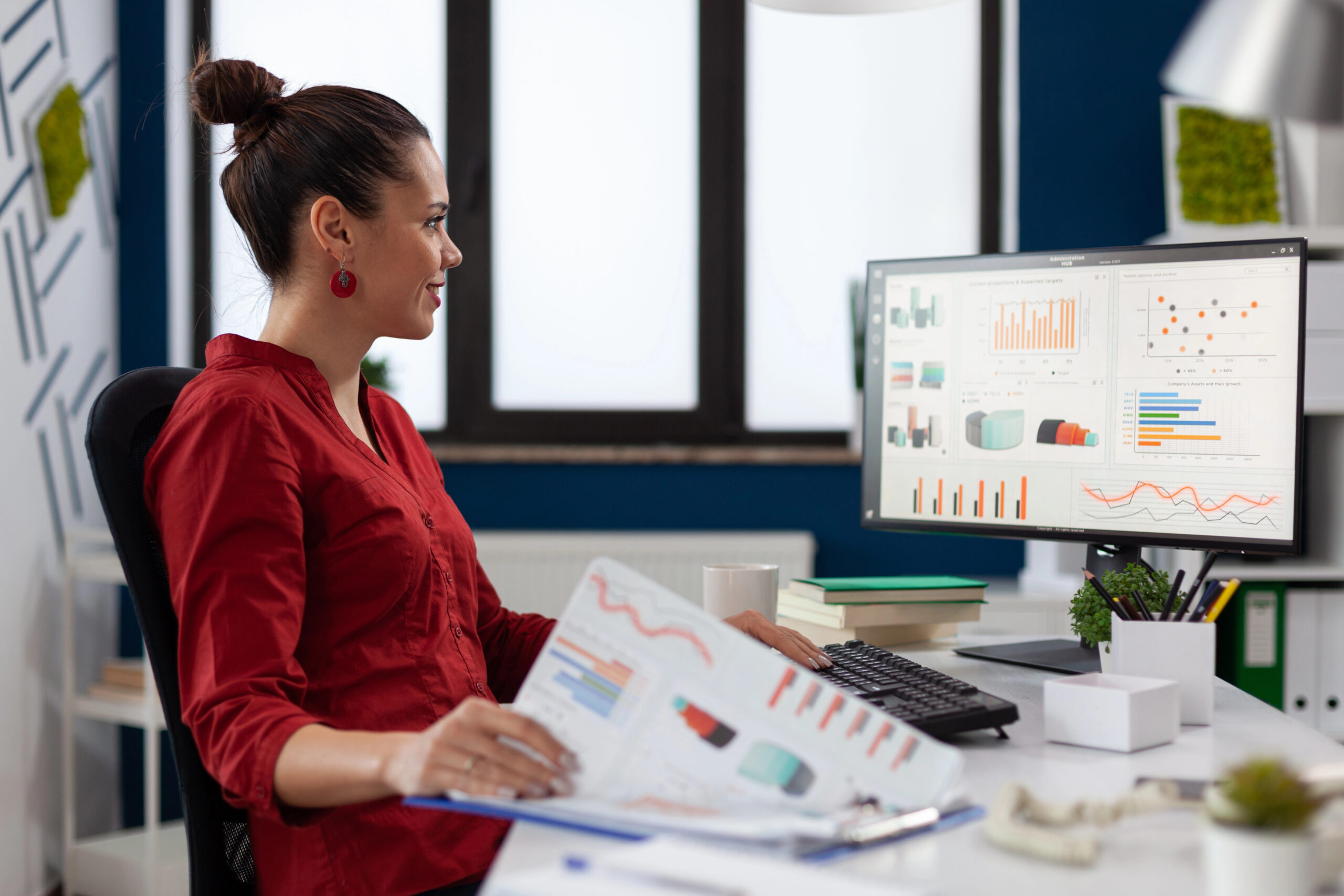 Woman at desk viewing a dashboard on her computer/